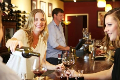 a group of people sitting at a table with wine glasses